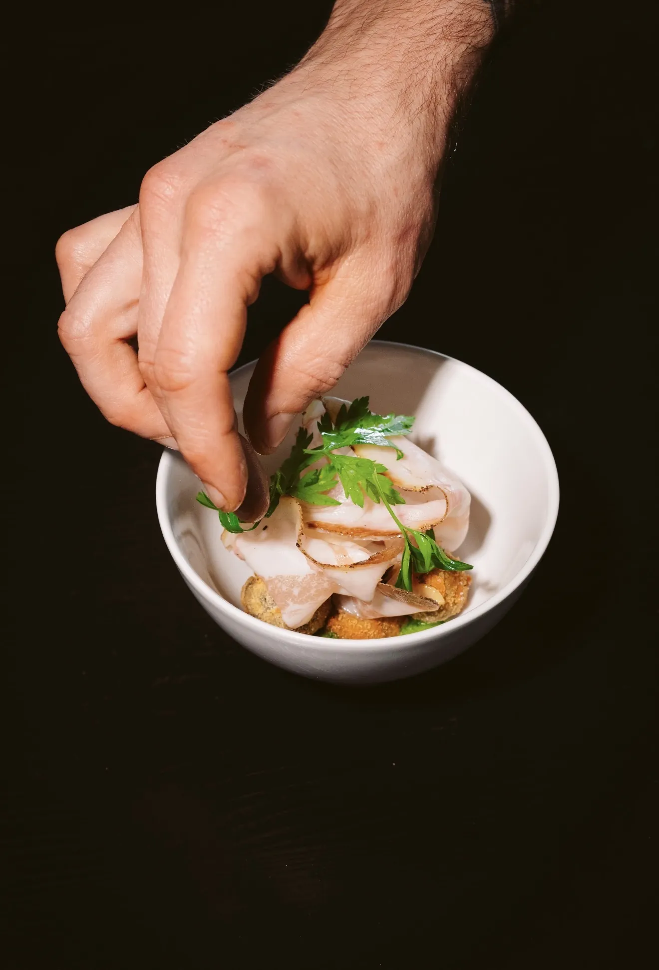 Chef garnishing a restaurant dish