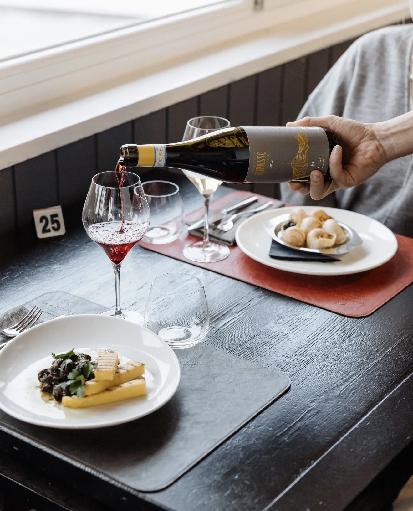 Wine poured alongside a restaurant dish