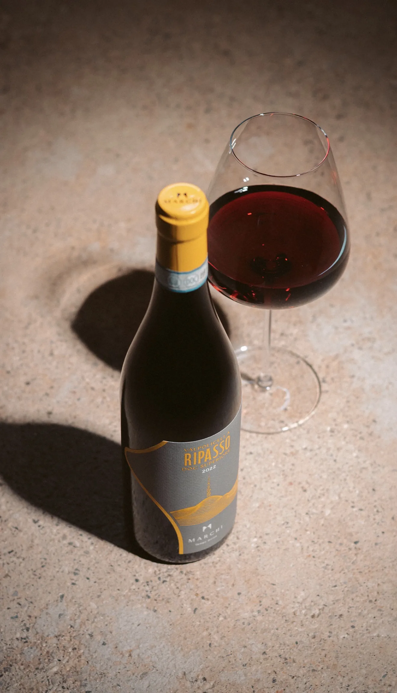 Wine bottle and glass photographed from above